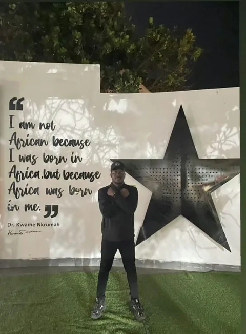 Me by the Kwame Nkrumah quote wall
